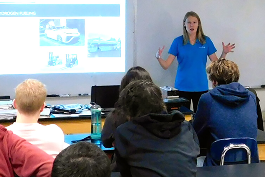A PA Dream Team member presenting in front of a classroom of students